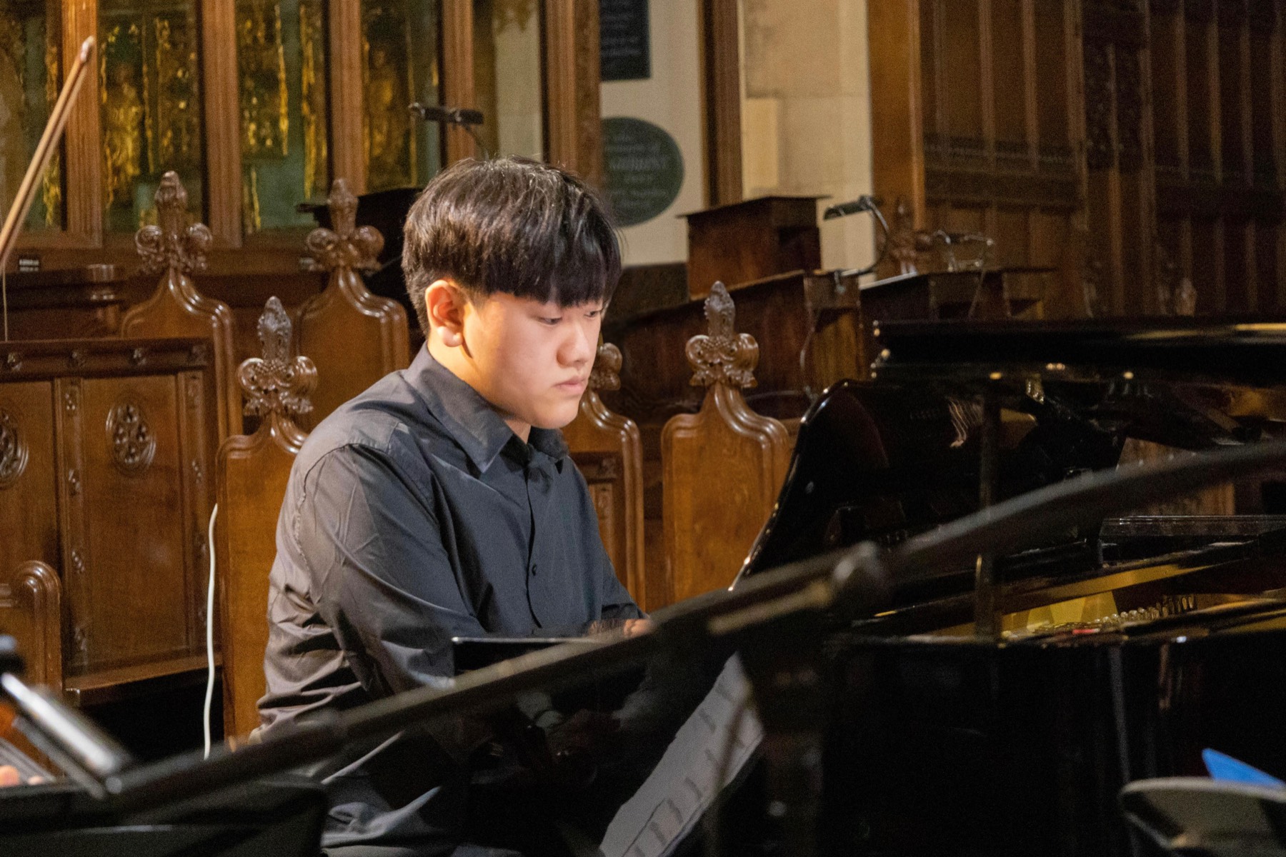 Bendit Chan performing at a grand piano